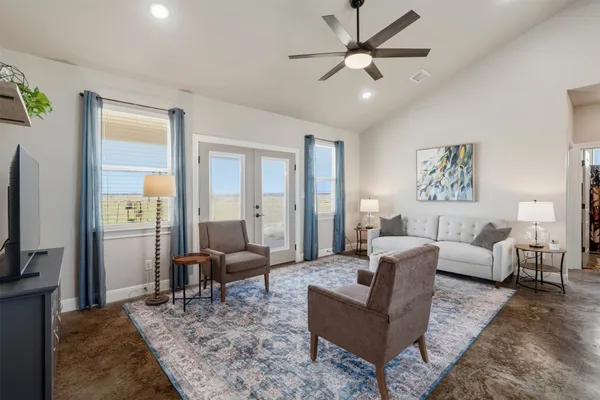 a living room with furniture ceiling fan and a rug
