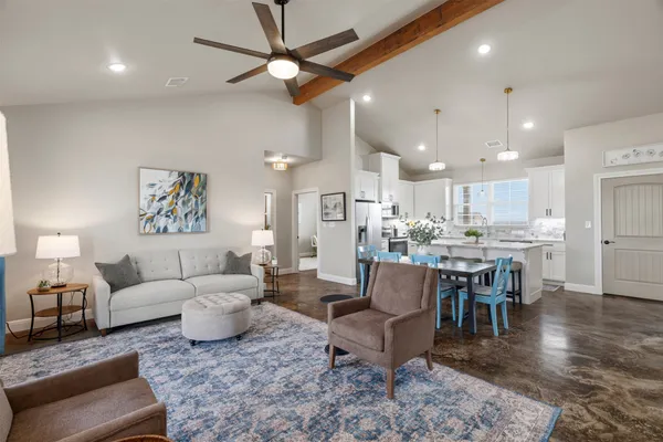 a living room with furniture kitchen view and a dining table