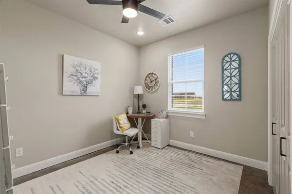 a bathroom with a granite countertop sink a toilet a mirror a vanity and bathtub
