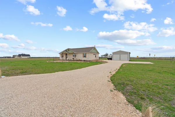 a view of a house with a yard and garage