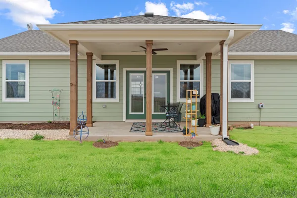 a front view of house with yard and green space
