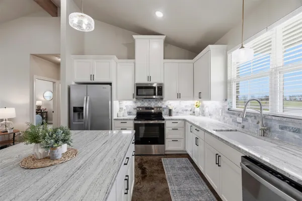 a kitchen with a sink stove and refrigerator