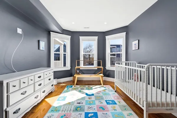 a bedroom with furniture and a wooden floor