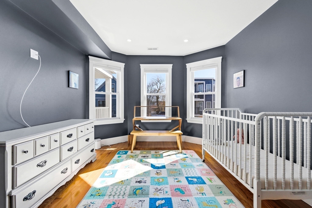 567 Park Street, Unit 2 Boston, MA 02124 - Photo 13 of 20 a bedroom with furniture and a wooden floor