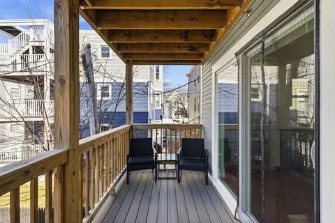 a view of balcony with wooden floor