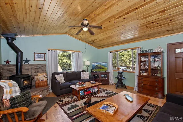 a living room with furniture a flat screen tv and a large window