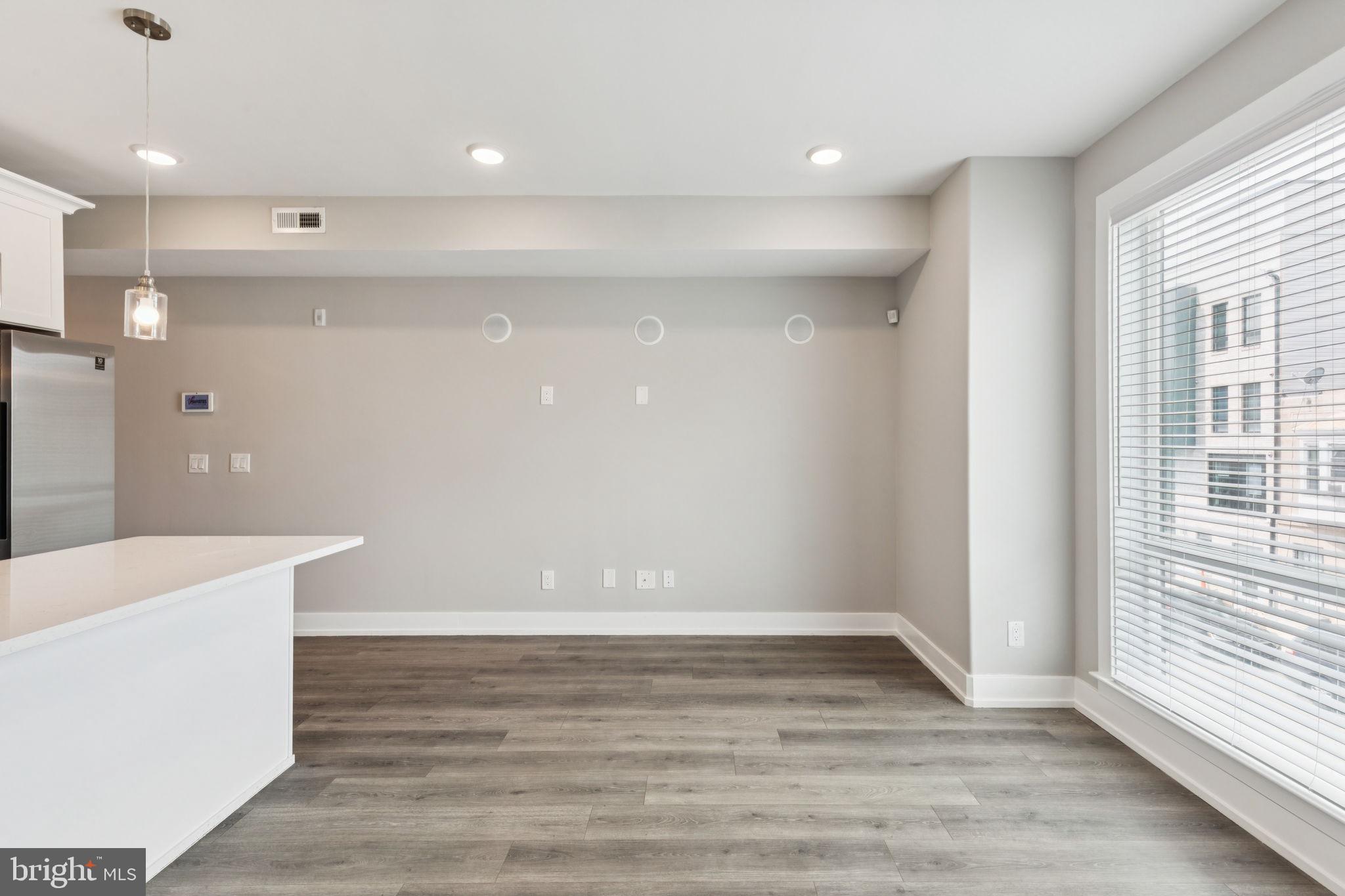 2531 North Front Street, Unit 2 Philadelphia, PA 19133 - Photo 13 of 25 a view of an empty room with wooden floor and a window