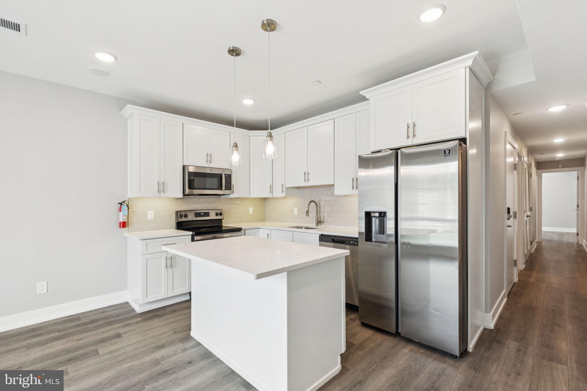 2531 North Front Street, Unit 2 Philadelphia, PA 19133 - Photo 4 of 25 a kitchen with stainless steel appliances a refrigerator a stove a sink and white cabinets
