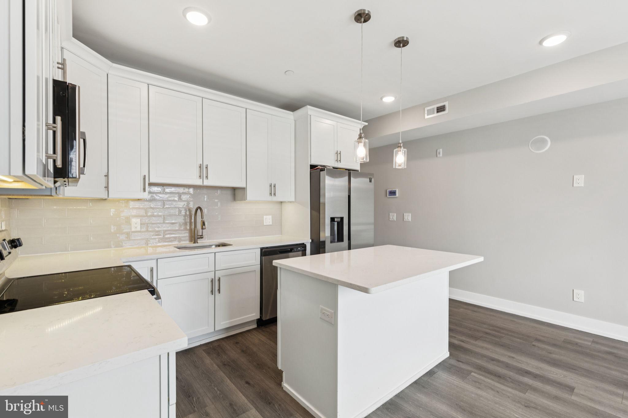 2531 North Front Street, Unit 2 Philadelphia, PA 19133 - Photo 6 of 25 a kitchen with a sink a stove a refrigerator and white cabinets