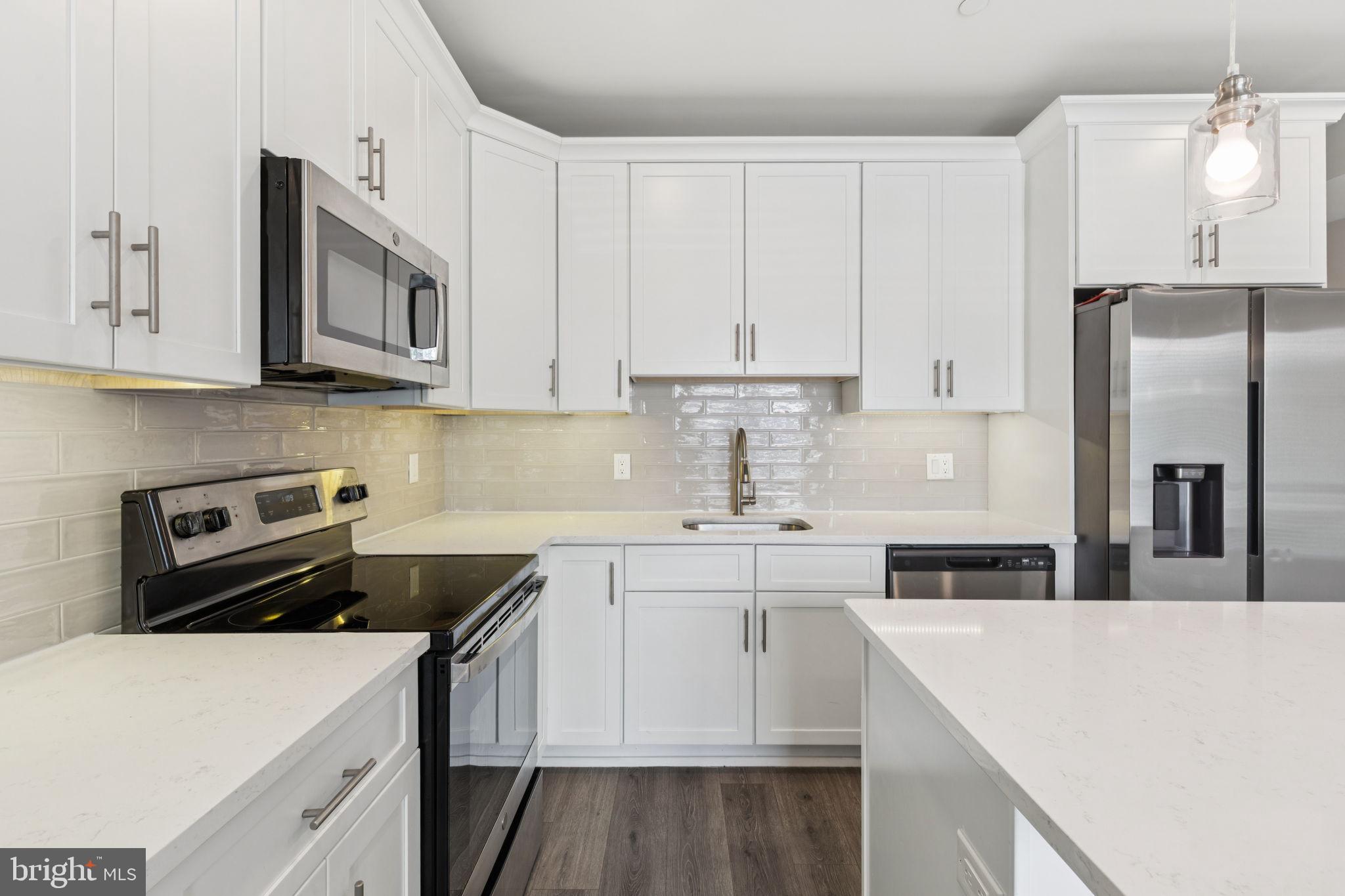 2531 North Front Street, Unit 2 Philadelphia, PA 19133 - Photo 7 of 25 a kitchen with stainless steel appliances a stove a sink a refrigerator and white cabinets