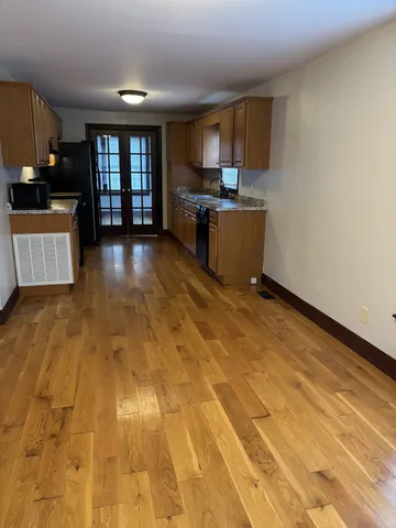 a kitchen with stainless steel appliances wooden cabinets a stove top oven a sink and dishwasher