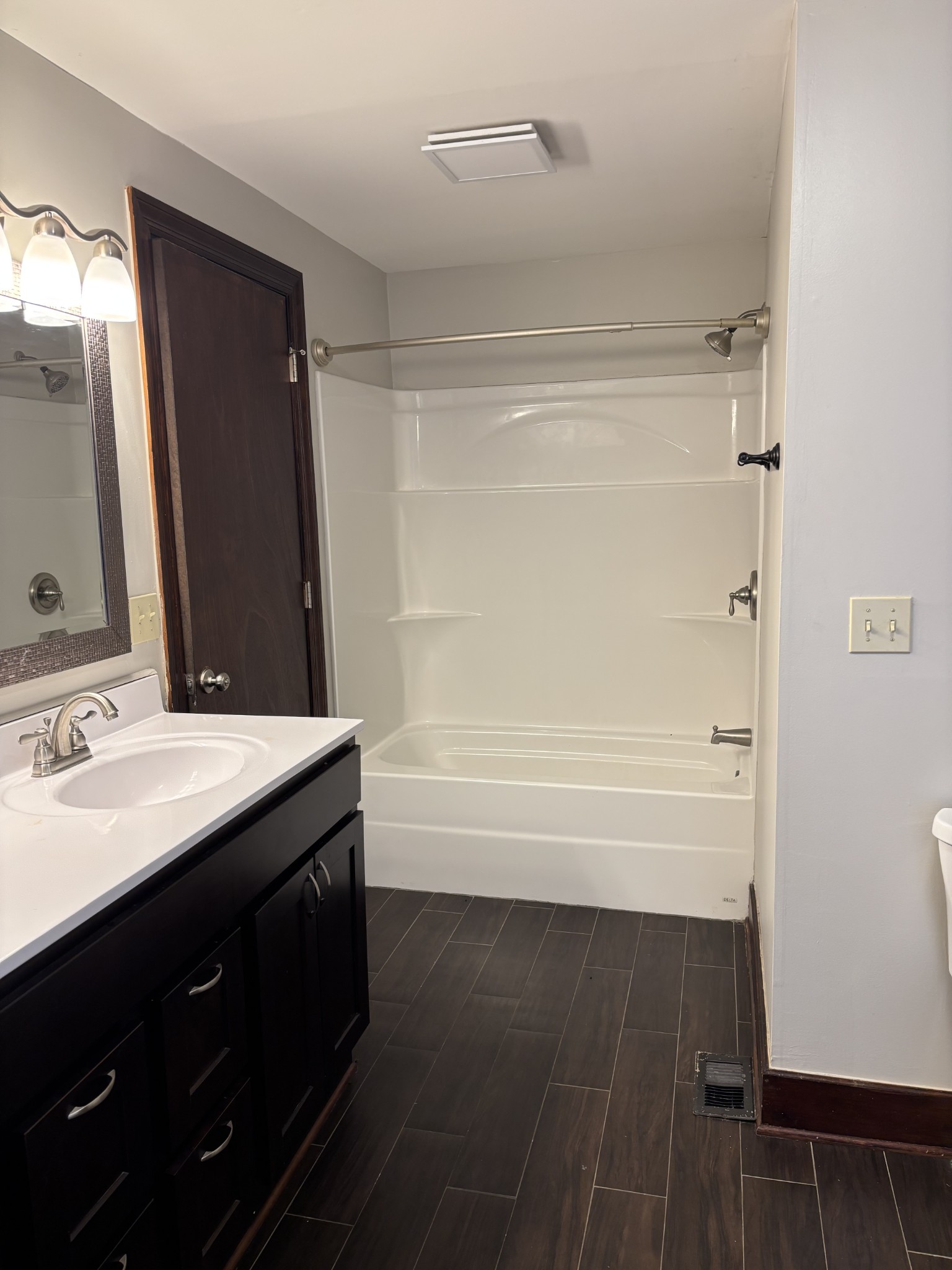 6315 Highway 49 East Springfield, TN 37172 - Photo 7 of 9 a bathroom with a double vanity sink a mirror and a bathtub