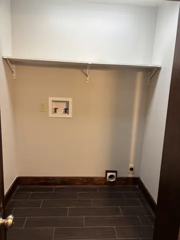 a view of an empty room and wooden floor