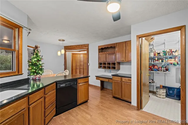a kitchen with granite countertop a sink and cabinets