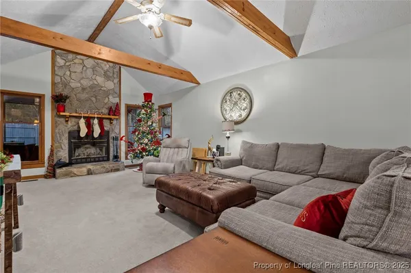 a living room with furniture a clock and a ceiling fan