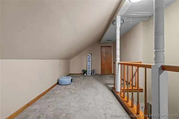 an empty room with staircase and white walls