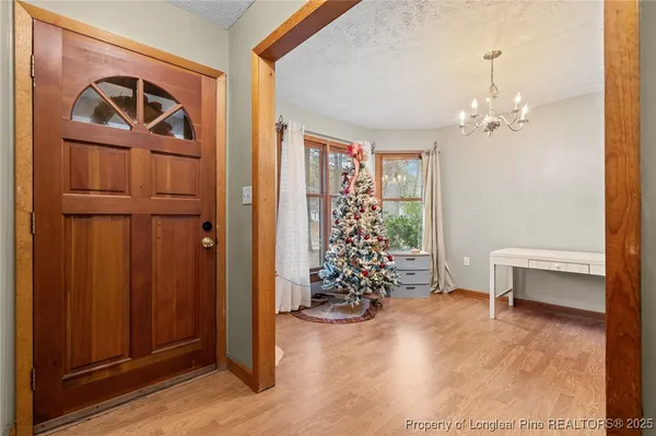 a view of a workspace with furniture and chandelier
