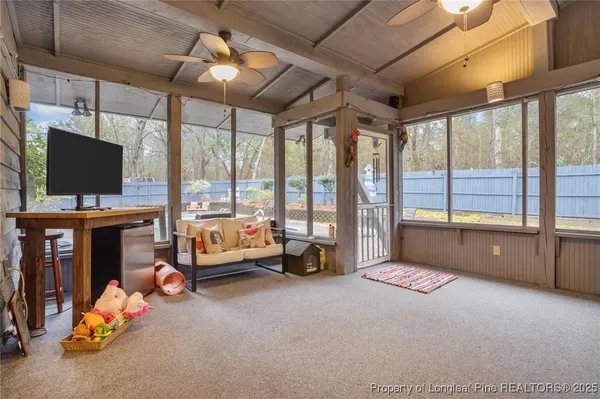 a view of a livingroom with furniture and a large window