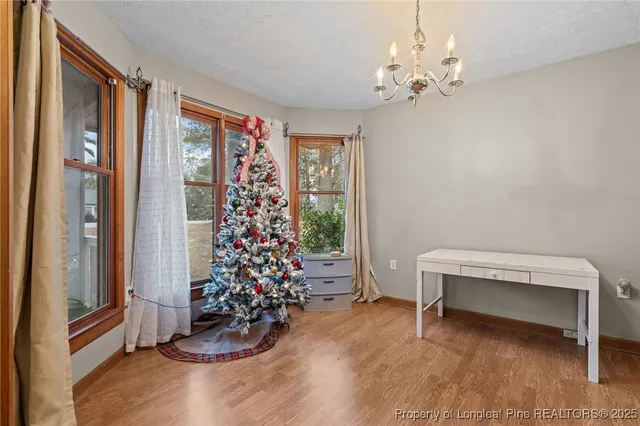 a view of a room with toys wooden floor and a window