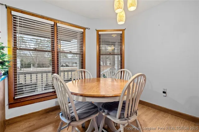 a view of a dining room with furniture window and wooden floor