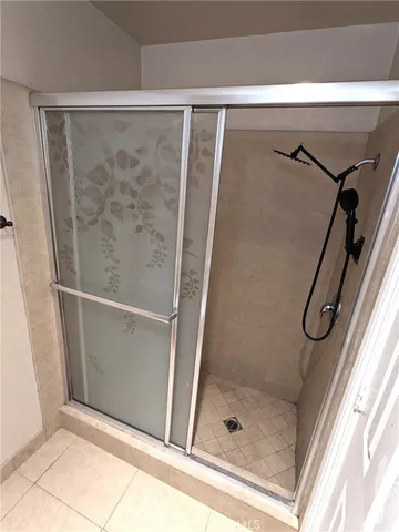 a bathroom with a glass shower door