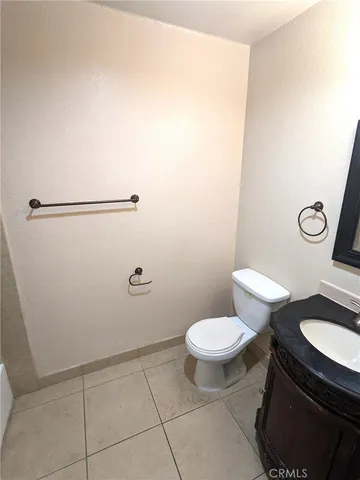 a white toilet sitting next to a shower curtain