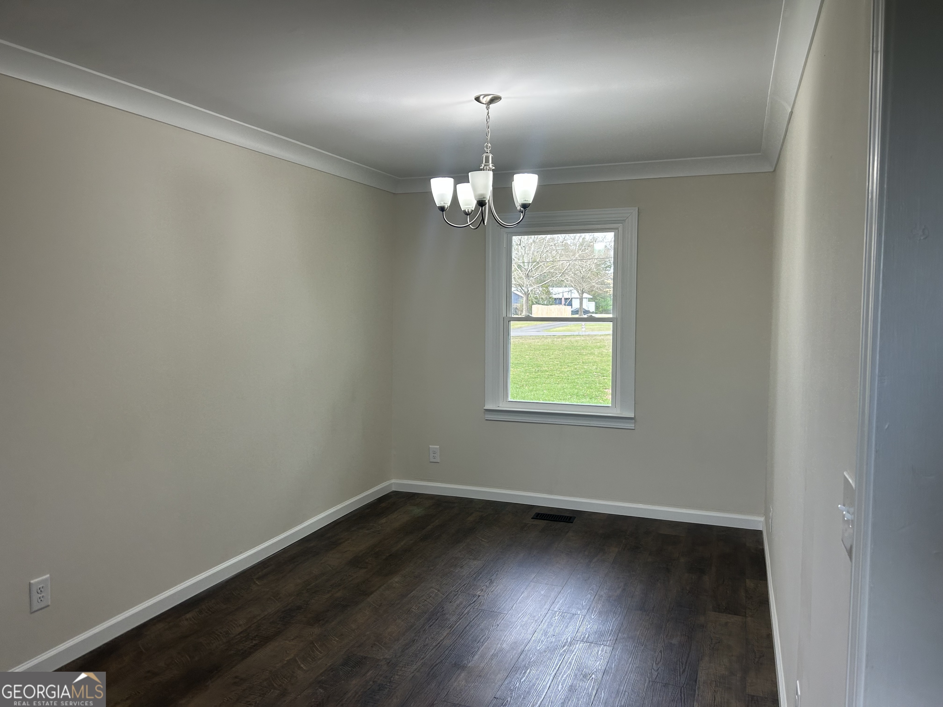 360 Warren Road Northeast Rome, GA 30165 - Photo 3 of 14 an empty room with wooden floor chandelier and windows