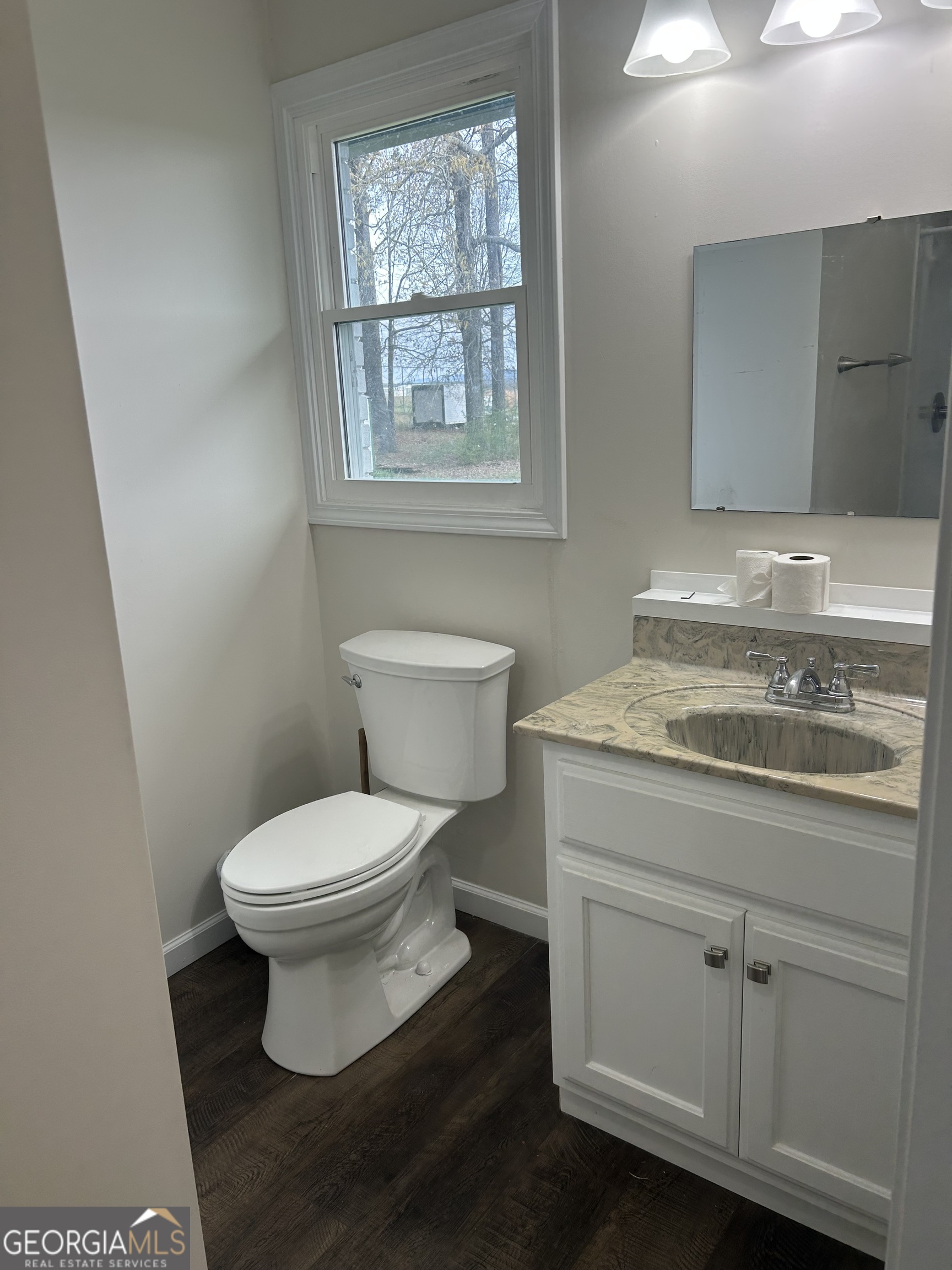 360 Warren Road Northeast Rome, GA 30165 - Photo 9 of 14 a bathroom with a granite countertop toilet a sink and a window