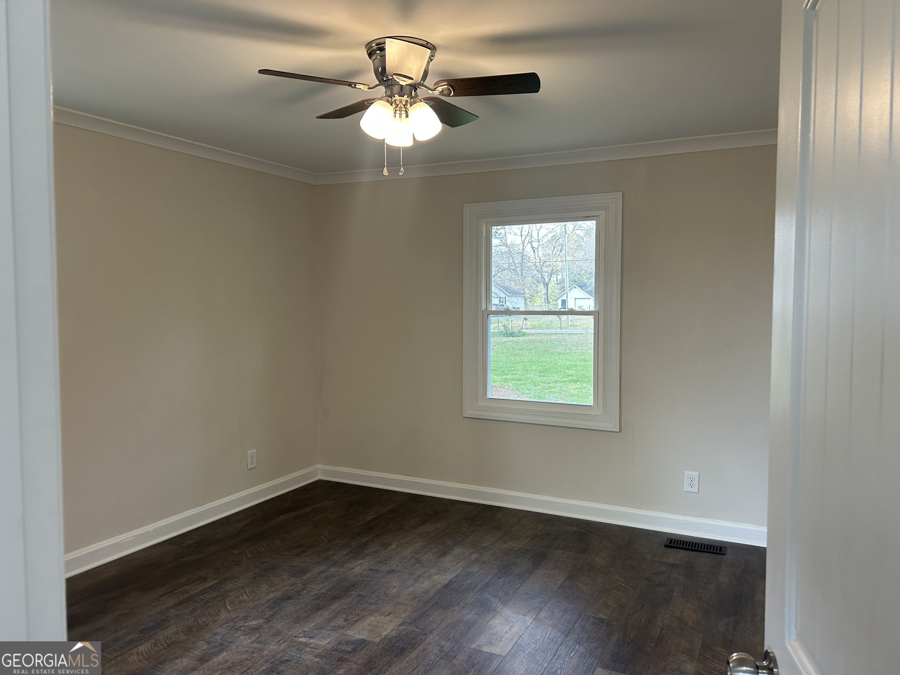 360 Warren Road Northeast Rome, GA 30165 - Photo 10 of 14 an empty room with wooden floor chandelier fan and windows