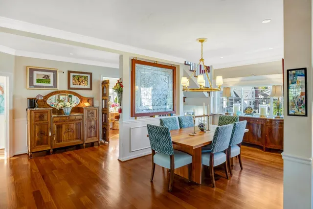 a dining room with furniture window and wooden floor