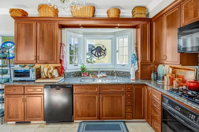 a kitchen with stainless steel appliances granite countertop a sink and cabinets