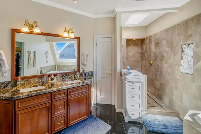 a bathroom with a double vanity sink mirror and shower