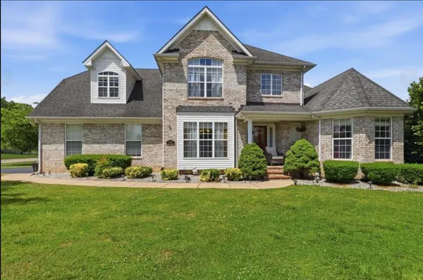 a front view of a house with a yard and porch
