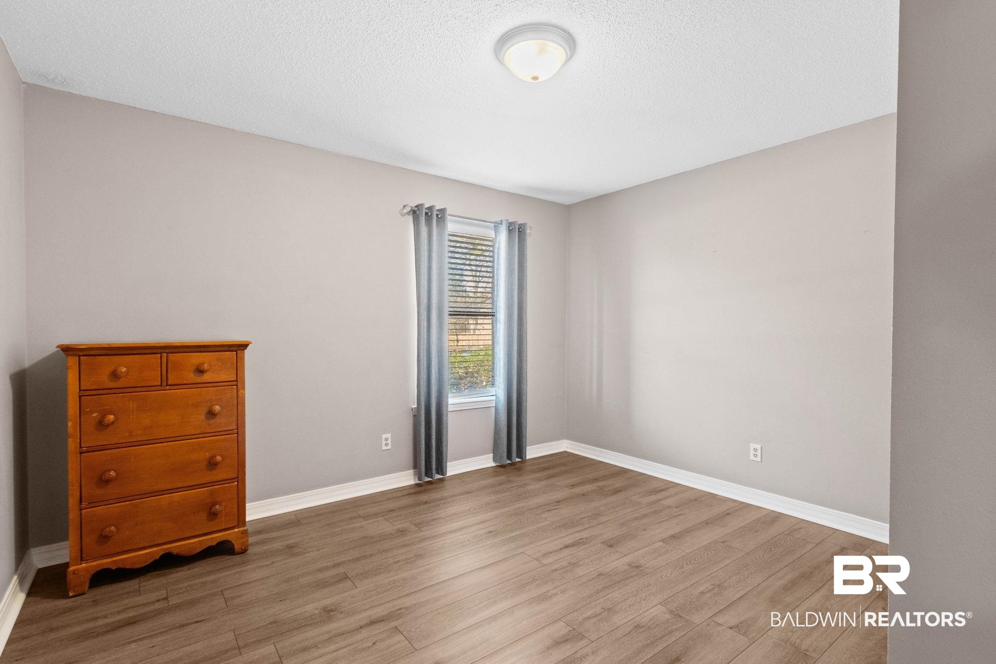 5366 Scanlan Way West Satsuma, AL 36572 - Photo 18 of 43 Unfurnished room featuring light wood-style flooring and a textured ceiling