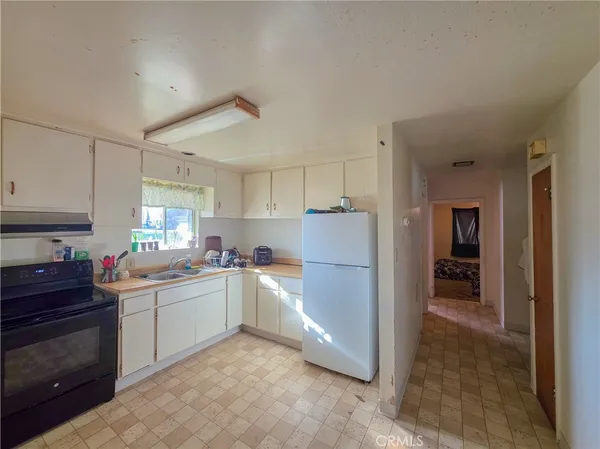 a kitchen with a sink and refrigerator
