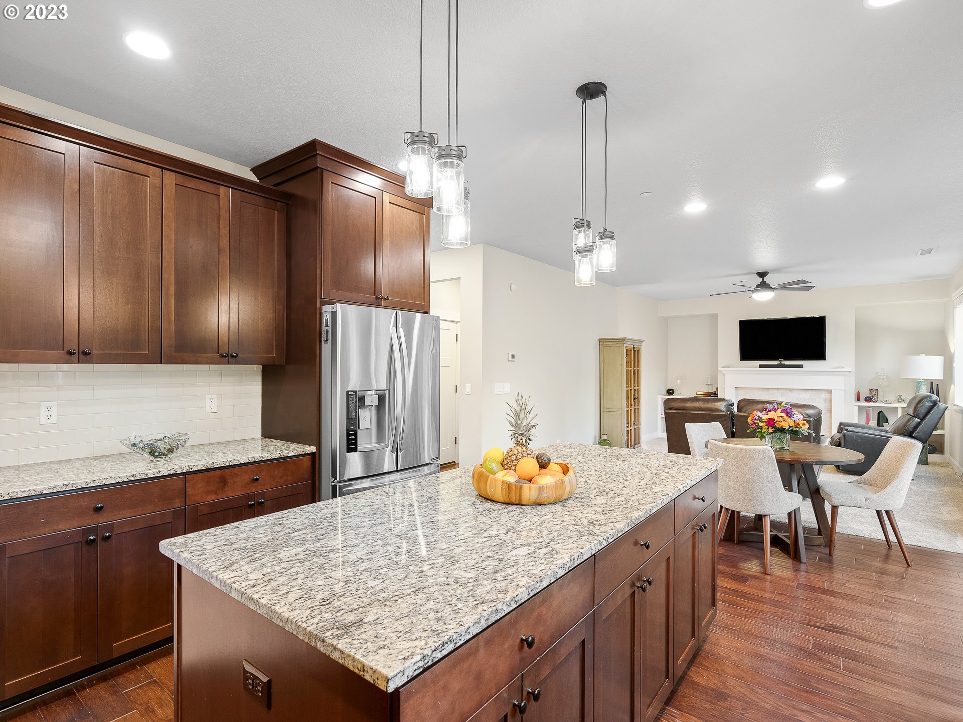 5420 Northwest 15th Circle Camas, WA 98607 - Photo 3 of 29 a kitchen with stainless steel appliances kitchen island granite countertop a table chairs and a refrigerator