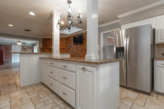 a bathroom with a granite countertop sink a mirror and a shower