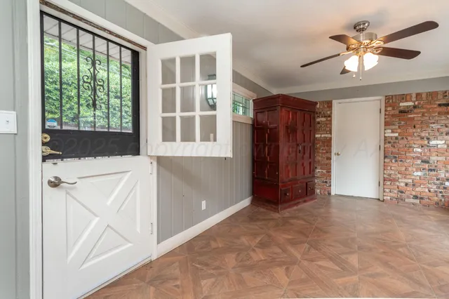 an entryway with wooden floor and cabinet