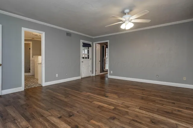 a view of an empty room with wooden floor