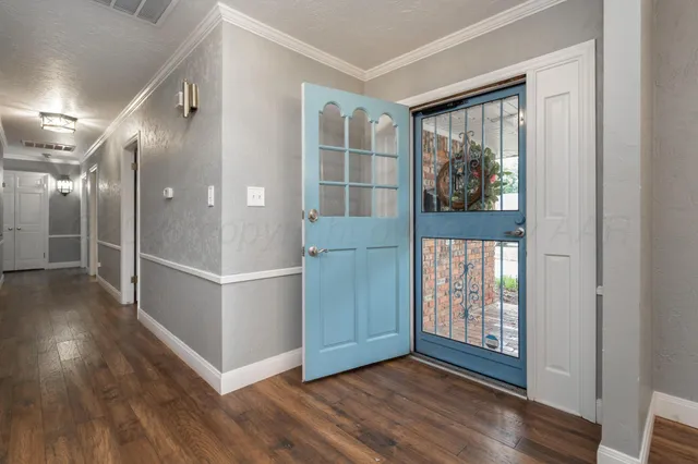 a view of an entryway with wooden floor and door