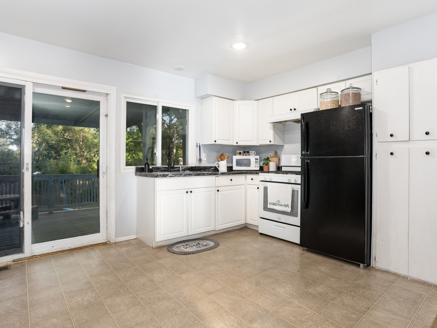 156 Bedford Road Bolingbrook, IL 60440 - Photo 3 of 16 a kitchen with white cabinets and white appliances