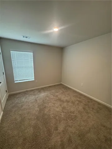 an empty room with a empty space and a window