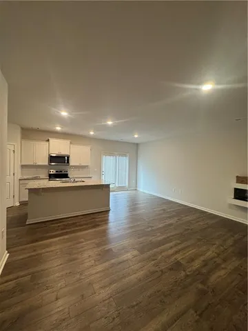 a view of kitchen with kitchen island wooden floor and center island