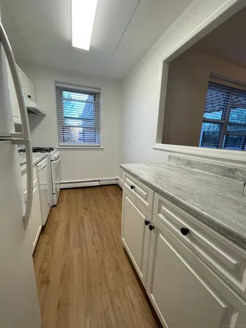 a view of a room with wooden floor and staircase