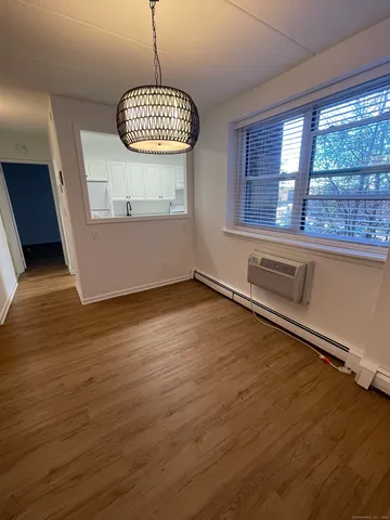 a room with wooden floor and window
