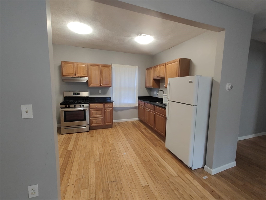30 Vine Street, Unit 2 Haverhill, MA 01830 - Photo 13 of 13 a kitchen with stainless steel appliances a refrigerator sink and microwave