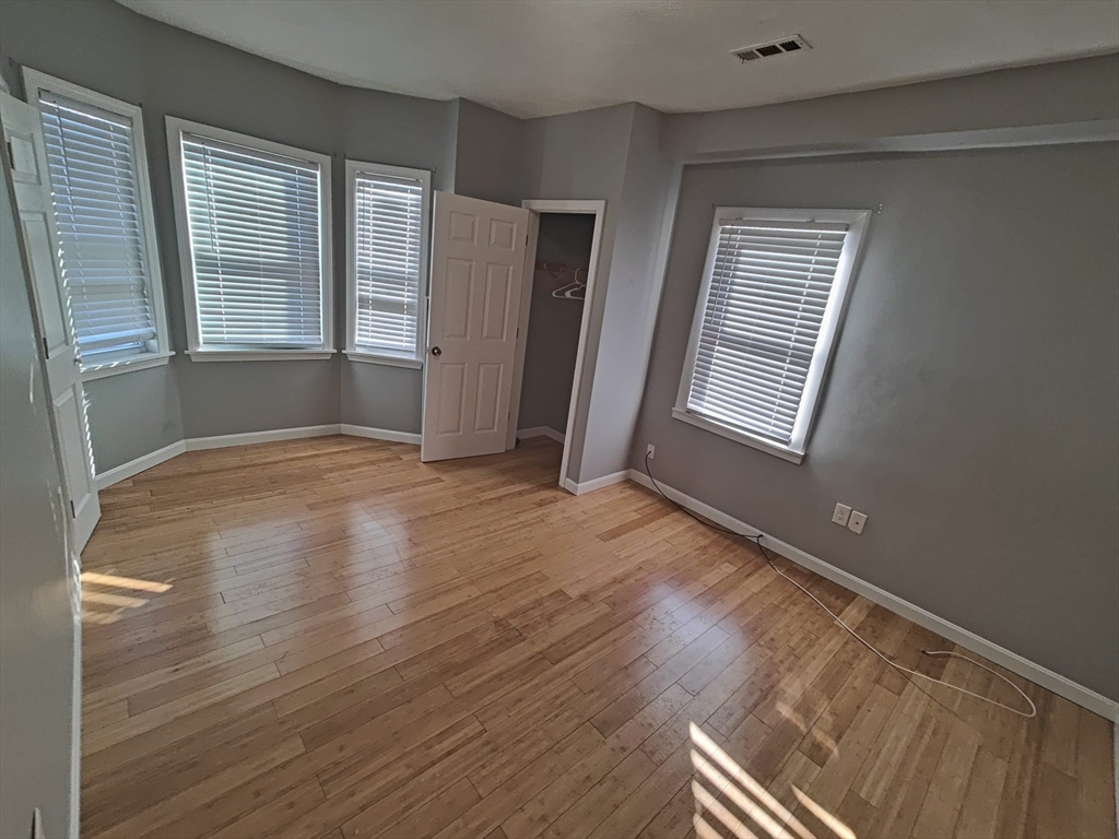30 Vine Street, Unit 2 Haverhill, MA 01830 - Photo 5 of 13 a view of an empty room with wooden floor and a window