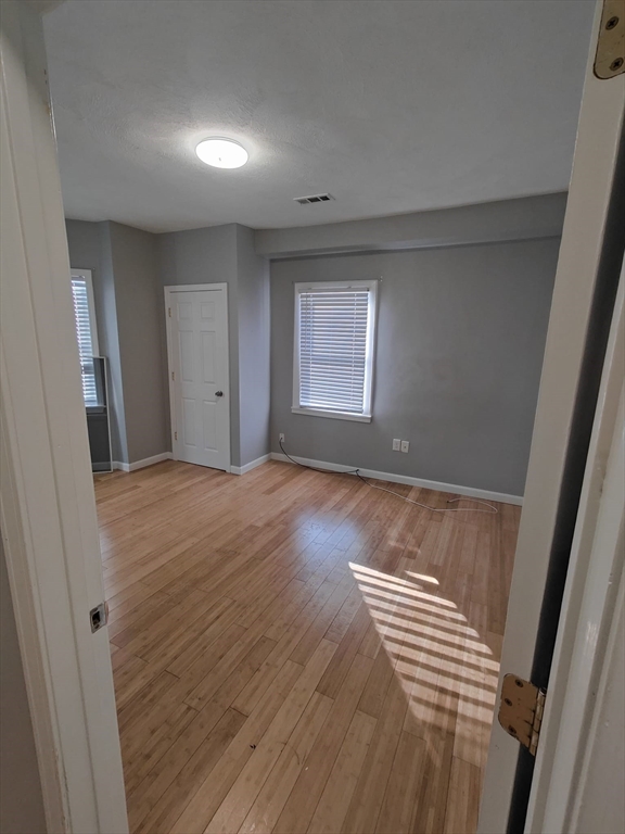 30 Vine Street, Unit 2 Haverhill, MA 01830 - Photo 6 of 13 a view of room with window and hardwood floor