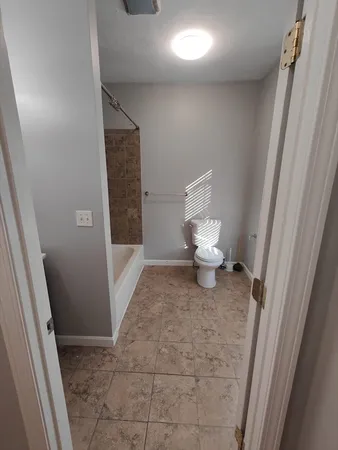a view of a hallway with toilet
