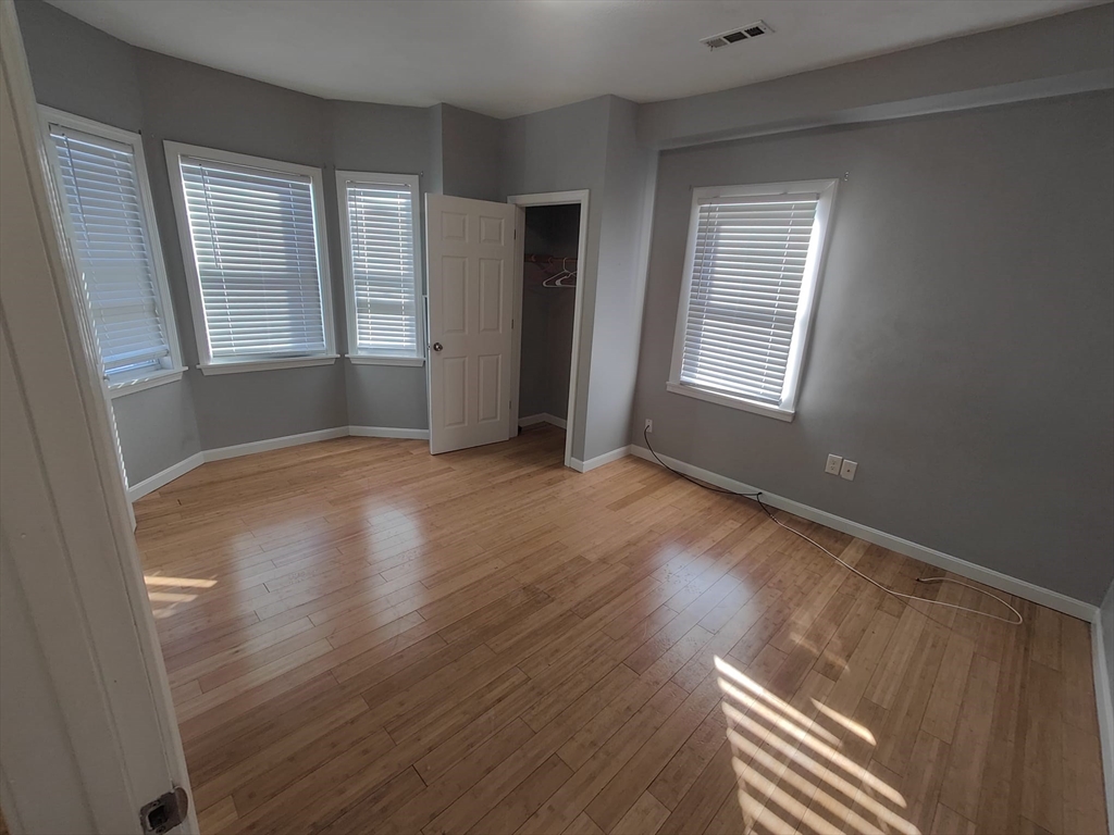 30 Vine Street, Unit 2 Haverhill, MA 01830 - Photo 10 of 13 a view of an empty room with wooden floor and a window